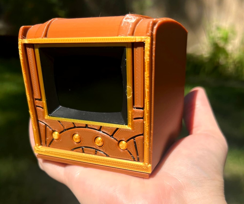 A hand holding the Pict-O-Vision Still outdoors