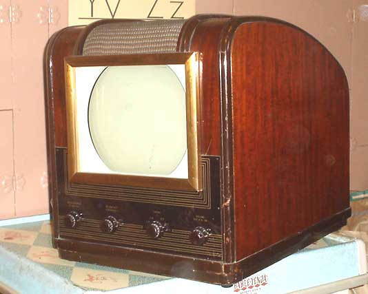 Vintage Electromatic 101 television with rounded wooden cabinet, gold bezel, and circular CRT screen